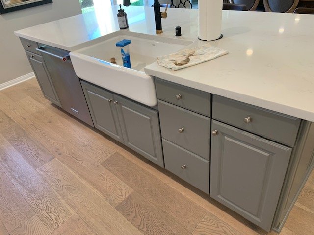 Gray island cabinets around a farmhouse sink