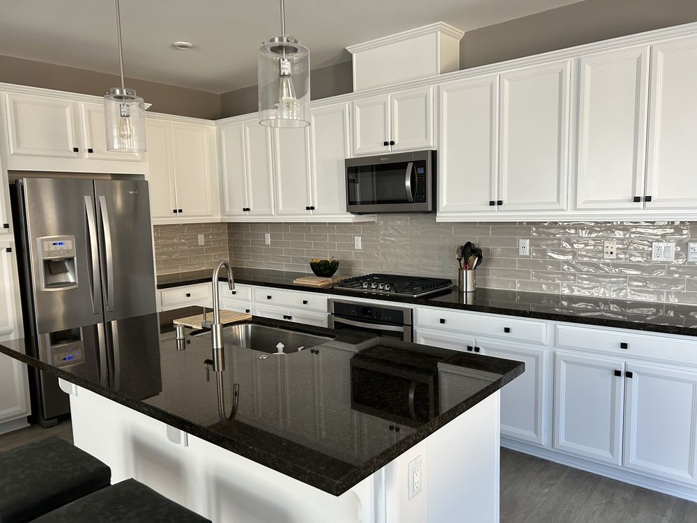 White kitchen cabinets with black granite counters