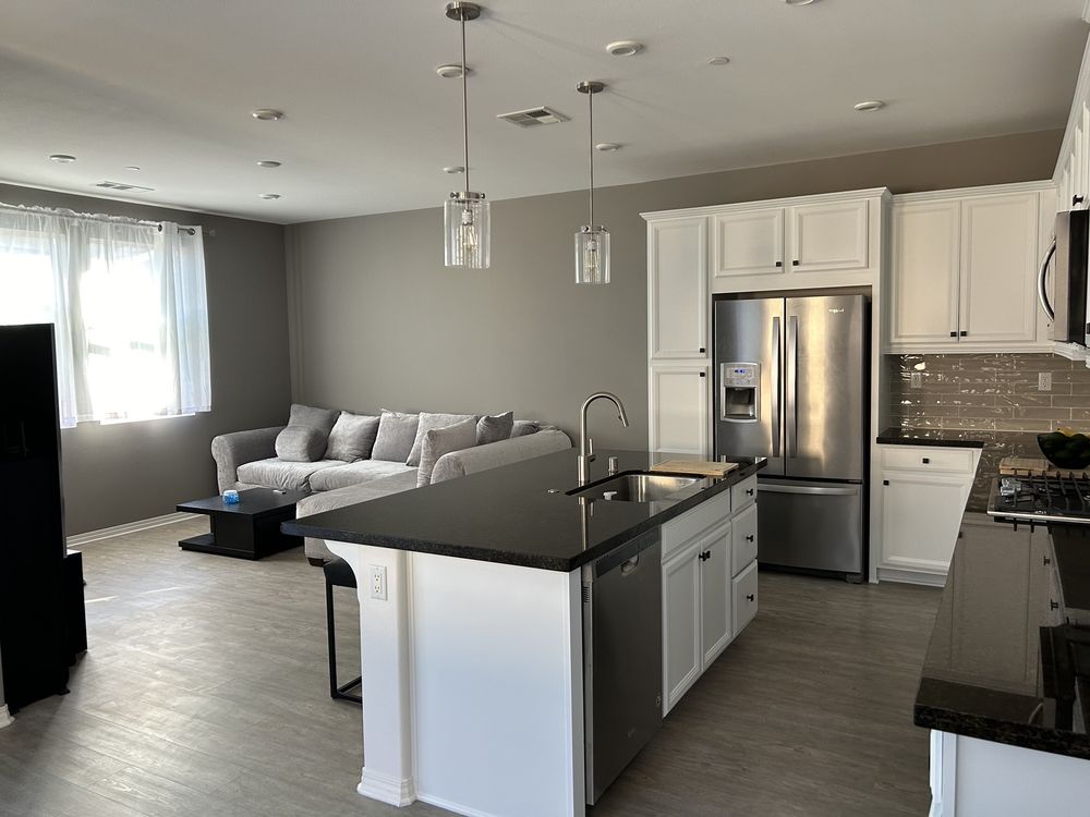 White kitchen island and cabinets in an open floor plan